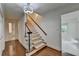 Bright foyer features hardwood floors, a staircase with carpet runner, and traditional design details at 5507 Martina Way, Dunwoody, GA 30338