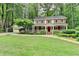 Charming two-story home with red shutters, white trim and a well-manicured lawn at 5507 Martina Way, Dunwoody, GA 30338