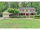 Charming two-story home with red shutters, white trim and a well-manicured lawn at 5507 Martina Way, Dunwoody, GA 30338