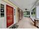 Inviting front porch with stone accents, a ceiling fan, and a charming view of the surrounding greenery at 5507 Martina Way, Dunwoody, GA 30338