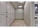 Hallway with built-in cabinets leads to modernly appointed bathroom at 5507 Martina Way, Dunwoody, GA 30338