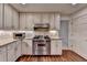 Bright kitchen features stainless steel appliances, granite countertops, and custom cabinets at 5507 Martina Way, Dunwoody, GA 30338