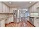 Spacious kitchen features stainless steel refrigerator and appliances with white cabinets at 5507 Martina Way, Dunwoody, GA 30338