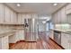 Spacious kitchen with stainless steel appliances, granite countertops, and wood flooring at 5507 Martina Way, Dunwoody, GA 30338