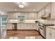 Well-lit kitchen with stainless steel appliances, light cabinets, and hardwood floors at 5507 Martina Way, Dunwoody, GA 30338