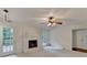 Cozy living room featuring painted brick fireplace and access to outdoor patio at 5507 Martina Way, Dunwoody, GA 30338