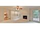 Inviting living room features brick fireplace, hardwood floors, and built-in shelving at 5507 Martina Way, Dunwoody, GA 30338