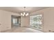 View of a bright living room with carpeted floor, and bright windows looking onto porch and yard at 5507 Martina Way, Dunwoody, GA 30338