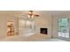 Bright living room showcasing a fireplace, built-in shelving, and access to kitchen at 5507 Martina Way, Dunwoody, GA 30338