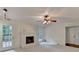 Inviting living room with a painted brick fireplace and french doors to deck at 5507 Martina Way, Dunwoody, GA 30338