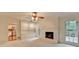 Open living room with fireplace and built-in shelves adjacent to kitchen at 5507 Martina Way, Dunwoody, GA 30338