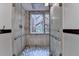 Modern shower with river rock floor and glass enclosure, offering a spa-like experience at 5507 Martina Way, Dunwoody, GA 30338