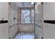 Modern glass shower with mosaic stone trim and rainfall shower head at 5507 Martina Way, Dunwoody, GA 30338