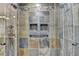 Contemporary walk-in shower featuring stylish tilework, dual shower heads, and convenient storage niches at 5507 Martina Way, Dunwoody, GA 30338