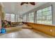 The sunroom has lots of windows offering a view of the backyard landscaping at 5507 Martina Way, Dunwoody, GA 30338