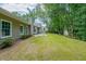 Beautiful backyard with a patio, lush green lawn, mature trees and storage shed at 780 Karingway Nw Ln, Kennesaw, GA 30152