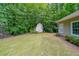 Spacious backyard with a shed, well-maintained lawn, and lush green trees creating a private oasis at 780 Karingway Nw Ln, Kennesaw, GA 30152