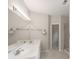 A modern bathroom has double sinks with quartz countertops, a large mirror, and custom lighting at 780 Karingway Nw Ln, Kennesaw, GA 30152