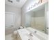 Bright bathroom features a large mirror, white vanity, and a window bringing in natural light at 780 Karingway Nw Ln, Kennesaw, GA 30152