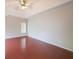 An airy bedroom features neutral paint, hardwood flooring and a ceiling fan at 780 Karingway Nw Ln, Kennesaw, GA 30152