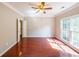 An airy bedroom features neutral paint, hardwood flooring and a ceiling fan at 780 Karingway Nw Ln, Kennesaw, GA 30152