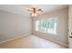 An airy bedroom features neutral paint, large windows and tile flooring at 780 Karingway Nw Ln, Kennesaw, GA 30152