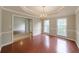The formal dining room has a modern chandelier, hardwood floors, and wainscotting at 780 Karingway Nw Ln, Kennesaw, GA 30152