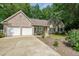 Attractive home with a two-car garage, well-maintained lawn, and mature trees at 780 Karingway Nw Ln, Kennesaw, GA 30152