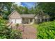 Charming one-story home featuring a two-car garage, brick accents, and lush landscaping at 780 Karingway Nw Ln, Kennesaw, GA 30152
