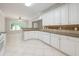 Bright kitchen features white cabinets, granite countertops, and tile flooring at 780 Karingway Nw Ln, Kennesaw, GA 30152
