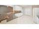 Bright eat-in kitchen with stone countertops, tiled floors, and white cabinetry at 780 Karingway Nw Ln, Kennesaw, GA 30152