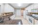 Spacious kitchen with stone countertops, white cabinets and stainless steel appliances at 780 Karingway Nw Ln, Kennesaw, GA 30152