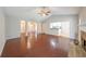 Open-concept living room featuring hardwood floors, an archway, fireplace, and ceiling fan at 780 Karingway Nw Ln, Kennesaw, GA 30152
