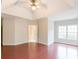 A spacious main bedroom with a ceiling fan, plush carpets, and lots of natural light at 780 Karingway Nw Ln, Kennesaw, GA 30152