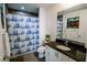 Well-lit bathroom featuring a single vanity, a patterned shower curtain, and modern fixtures at 270 17Th Nw St # 3804, Atlanta, GA 30363