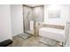 Well-lit bathroom offering a large tub, separate shower stall and tiled floors at 270 17Th Nw St # 3804, Atlanta, GA 30363