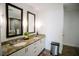 Bathroom featuring double sinks with a granite countertop, two mirrors and tiled floors at 270 17Th Nw St # 3804, Atlanta, GA 30363
