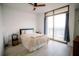Bright bedroom with a ceiling fan, wood floors, and a large window overlooking the city at 270 17Th Nw St # 3804, Atlanta, GA 30363