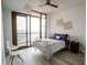 Cozy bedroom featuring hardwood floors, city views, and a ceiling fan at 270 17Th Nw St # 3804, Atlanta, GA 30363