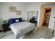 Comfortable bedroom featuring a bed with blue bedding, a closet with mirrored doors, and neutral walls at 270 17Th Nw St # 3804, Atlanta, GA 30363