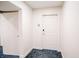 Hallway with white door, baseboards, and carpet with geometric design at 270 17Th Nw St # 3804, Atlanta, GA 30363