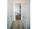 Hallway with a decorative rug, tiled floors and doors to the bath, laundry and closet areas at 270 17Th Nw St # 3804, Atlanta, GA 30363