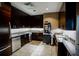 Kitchen with stainless appliances, granite counters, modern lighting, and dark wood cabinets at 270 17Th Nw St # 3804, Atlanta, GA 30363