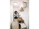 Well-lit laundry room with a stacked washer and dryer, plus storage shelves and a small folding table at 270 17Th Nw St # 3804, Atlanta, GA 30363