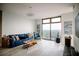 Bright living room showcasing a comfortable blue sofa, hardwood floors, and expansive windows with city views at 270 17Th Nw St # 3804, Atlanta, GA 30363