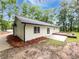 Home showcasing a side yard with a deck, patio, and well-maintained lawn at 2734 Amber Springs Way, Buford, GA 30519
