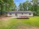 Home featuring a backyard with a deck, patio and spacious green yard at 2734 Amber Springs Way, Buford, GA 30519