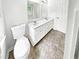 Bathroom featuring a double sink vanity, tiled floors, and a separate toilet at 2734 Amber Springs Way, Buford, GA 30519