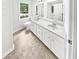 Bright bathroom featuring double vanity with white cabinetry and updated countertops at 2734 Amber Springs Way, Buford, GA 30519