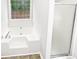 Bright bathroom featuring a modern tub and a separate glass-enclosed shower at 2734 Amber Springs Way, Buford, GA 30519